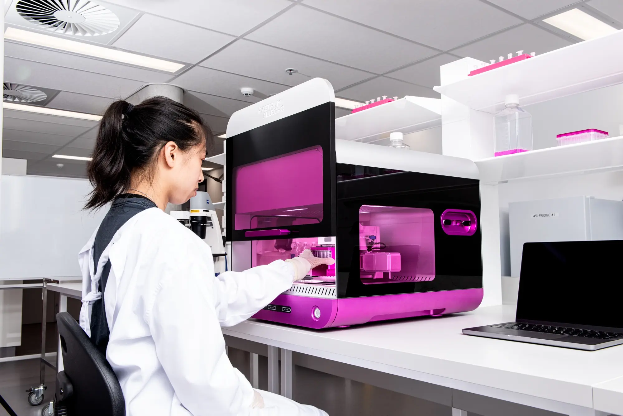 Scientist operating the RASTRUM Allegro 3D cell culture platform in a lab. The system enables high-throughput, reproducible 3D cell model generation for drug discovery and translational research.